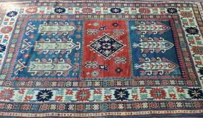 an oriental rug on a wooden floor with a blue and red design