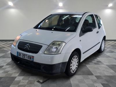 a picture of a small white car parked in a garage