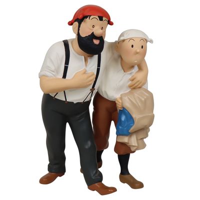 two figurines of a man and a woman holding a baby