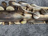 a close up of a saxophone on a blue cloth