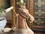 a wooden rocking horse with a flag on it