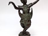 bronze statue of a woman holding a bird on a pedestal