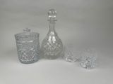 three glasses and a decanter sitting on a table