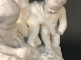 a statue of a boy and a girl playing with a baby