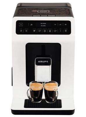 the krups coffee machine has two cups of coffee in front of it