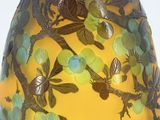 a yellow vase with birds and flowers painted on it