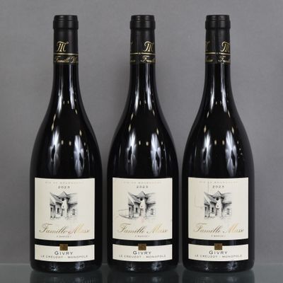 three bottles of wine are lined up on a table