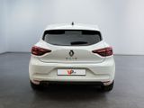the rear end of a white car in a white room