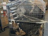 a cage with a bird inside of it that is wrapped in plastic