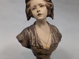 statue d'une femme en robe, portant un collier autour du cou