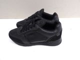 black sneakers with laces on the soles on a white surface