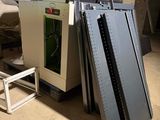 a machine that is sitting on the ground next to a pile of books