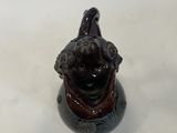 a small figurine of a dog with a hat on it