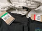 a pair of black pants and a white sweater on a table