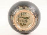 a close up of a vase with writing on it