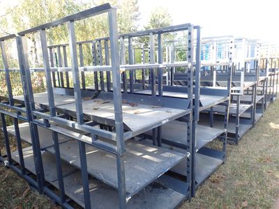 a lot of empty tables and benches in the grass