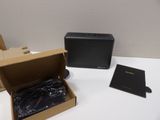 a box with a black speaker in it on a table