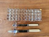three knives and a glass holder on the table