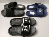 three pairs of black and white slippers on a white surface