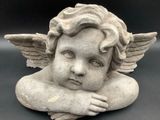a statue of a little angel with wings on it ' s head