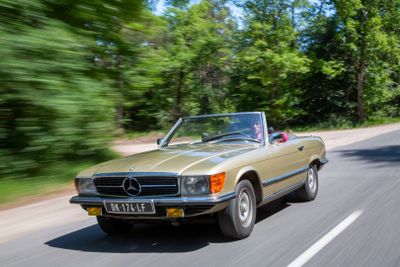 a car that is driving down the road in the daytime