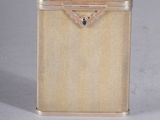 a small metal box with a handle on a white surface