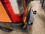 a close up of the rear end of a truck with the tail light on