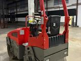 a red and black machine that is parked in a warehouse
