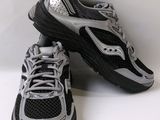pair of black and silver running shoes sitting on a white surface