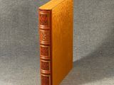 an old book sitting on top of a table next to a gray surface