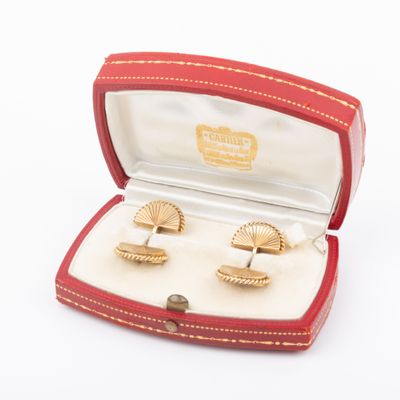 two pairs of cufflinks in a red box on a white surface