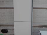 a tall white refrigerator sitting on top of a cardboard box