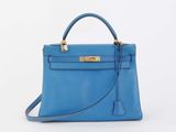 a blue leather handbag on a white background