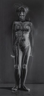 un dessin en noir et blanc représentant une femme debout devant un mur
