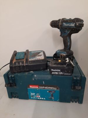 a cordless drill and two batteries on top of a tool box