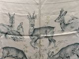 a picture of a group of deers on a table cloth