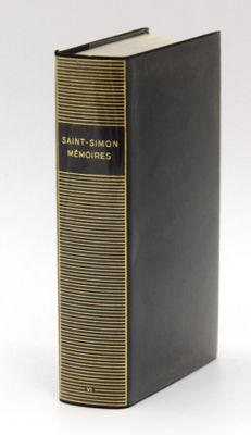 a black book sitting on top of a white table next to a white wall