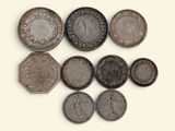 six different types of coins on a white surface