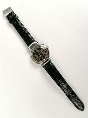 a close up of a watch on a white surface with a white background
