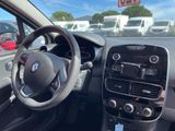 a steering wheel and dashboard of a car in a parking lot