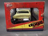 a yellow toy car in a box on a table