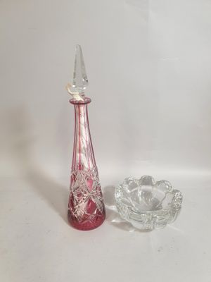 a glass vase and a glass ashtray on a white background