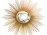 gold sunburst wall mirror with a mirror in the middle of it