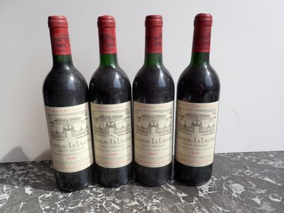 three bottles of red wine sitting on top of a table