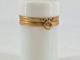 an image of a white jar with a gold band around it