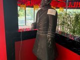 a statue of a man that is standing in front of a window