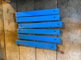 a blue bench that is on the side of a wall
