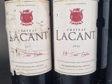 three bottles of red wine are lined up on a table