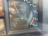 a close up of a clock on the dashboard of a car