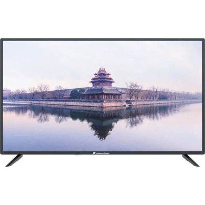 a black television sitting on top of a white table next to a lake
